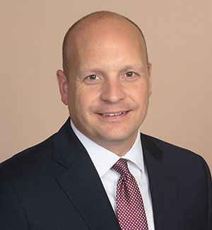 A headshot of Adam Klutts, President and CEO of the Peninsula Metropolitan YMCA